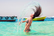 Foto: Young brunette jumping out of turquoise water of Red Sea, Egypt Young brunette jumping out of turquoise water of Red Sea, Egypt