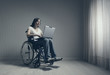 Foto: Disabled young woman using laptop Disabled young woman using laptop