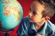 boy looking at globe