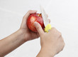 A woman pealing apple with knife