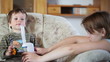 Mother and little boy using nebulizer to inhale medicine