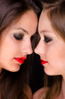 Profiles of two beautiful girls being intimate