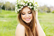 beautiful girl in wreath of flowers
