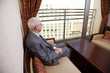 Senior Businessman Looking Out the Window