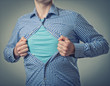 Businessman showing a superhero suit underneath his suit