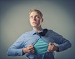 Businessman showing a superhero suit underneath his suit