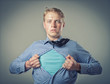 Businessman showing a superhero suit underneath his suit