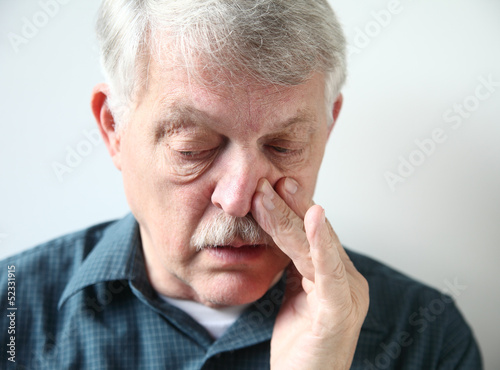 Photo: man with stuffy nose from allergies or cold man with stuffy nose from allergies or cold