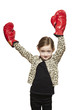 Photo: Young girl wearing boxing gloves smiling Young girl wearing boxing gloves smiling