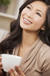Beautiful Chinese Oriental Asian Woman Drinking Tea or Coffee