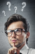 man with question marks over his head