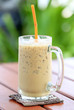 Iced coffee with straw in a glass on the table