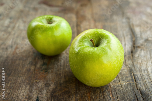Photo: Green apples on wood table Green apples on wood table