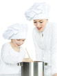Photo: Mother and child have fun in the kitchen, cooking together Mother and child have fun in the kitchen, cooking together