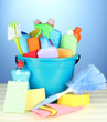 Cleaning items in bucket on  color background