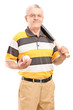 Mature man holding a baseball bat and ball