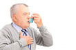 Mature man taking asthma treatment