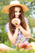 Beautiful woman in the garden with apples