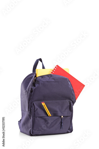 Photo: Studio shot of a school backpack with books Studio shot of a school backpack with books