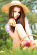 Beautiful woman in the garden with apples