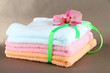 Towels tied with ribbon on gray background