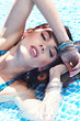 Sexy girl relaxing in a pool