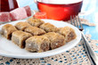 Sweet baklava on plate with tea on table