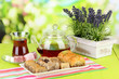Sweet baklava on plate with tea on table on bright background