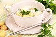 Tender young potatoes with sour cream and herbs in pan