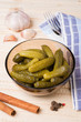 pickled cucumbers in a plate on a wooden surface