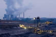 A large excavator digging at night in a brown-coal mine