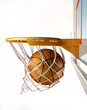 Basket ball centering the basket, close up view.