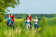 Family cycling outdoors in summer