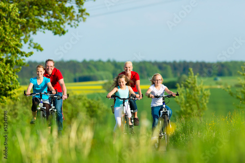 Photo: Family cycling outdoors in summer Family cycling outdoors in summer