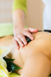Foto: woman having wellness hot stone massage woman having wellness hot stone massage