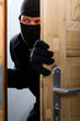 Burglary crime - burglar opening a door