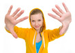Happy teenager girl stretching palms in camera