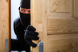 Burglary crime - burglar opening a door