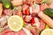 Foto: raw meat with rosemary, lemon on a white background raw meat with rosemary, lemon on a white background