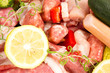 Foto: raw meat with rosemary, lemon on a white background raw meat with rosemary, lemon on a white background
