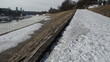 snow path along the river in the distance skyscrapers and bridge