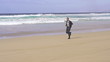 Businessman jogging on the beach, super slow motion, shot at 240