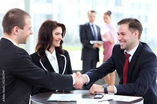 Photo: Business people shaking hands, finishing up a meeting Business people shaking hands, finishing up a meeting