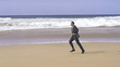 Businessman jogging on the beach, super slow motion, shot at 240