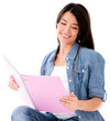 Female student reading a notebook