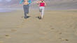 Man and woman jogging on the beach
