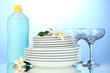 empty clean plates and glasses with dishwashing liquid