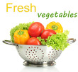 Fresh vegetables in silver colander isolated on white