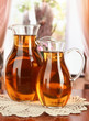Apple juice in pitchers on table in room