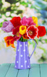 Beautiful tulips in bouquet on table on bright background